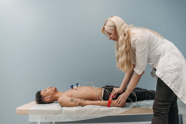 ConMed or 3M ECG electrodes being placed on a patient’s chest
