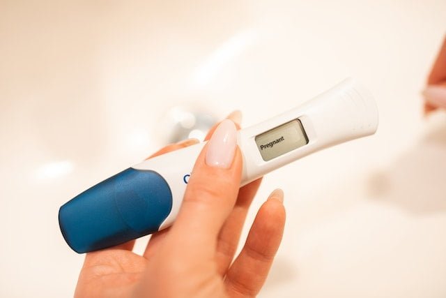 A pregnancy test strip indicating a positive result