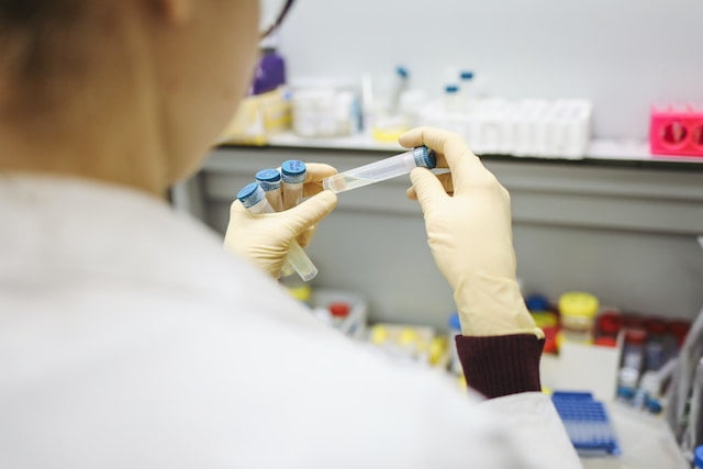 A technician holding a sample for the COVID test