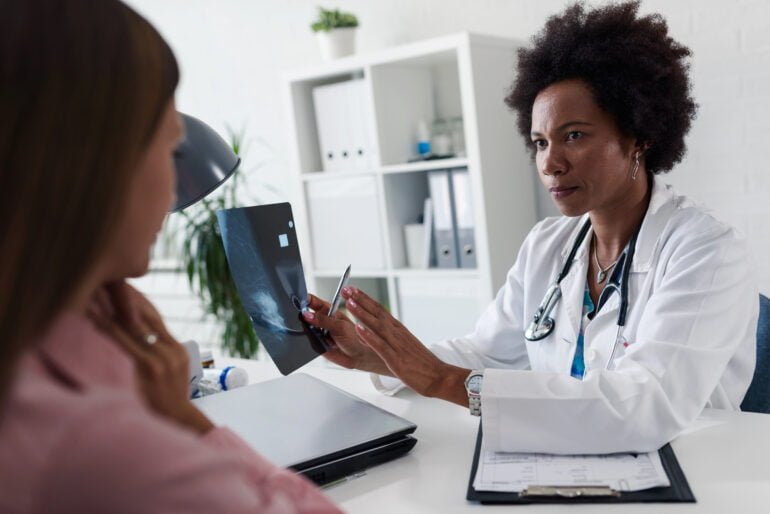 A doctor discusses mammogram findings related to breast cancer with a patient



