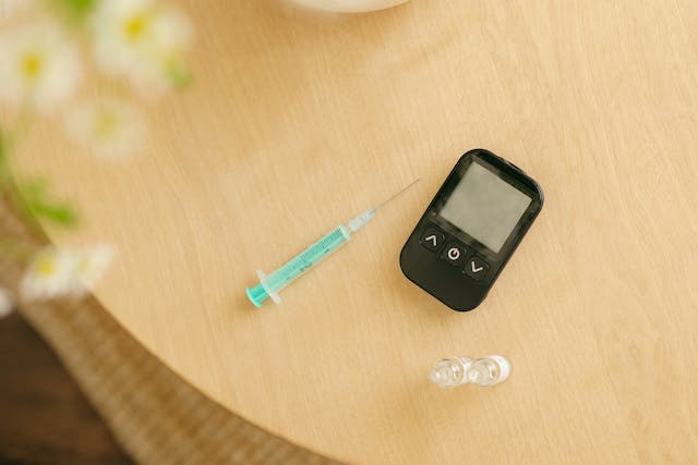 An insulin syringe and a glucometer