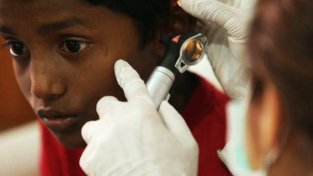 A physician examining a child’s ear using a KaWe Combilight C10 otoscope