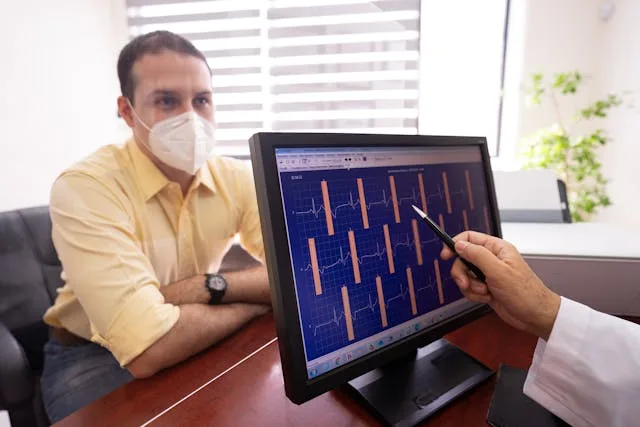 A physician analyzing the ECG results of a patient recorded using a wearable ECG machine