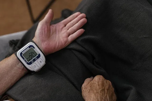 Wireless wrist blood pressure monitor being used by a patient in home settings