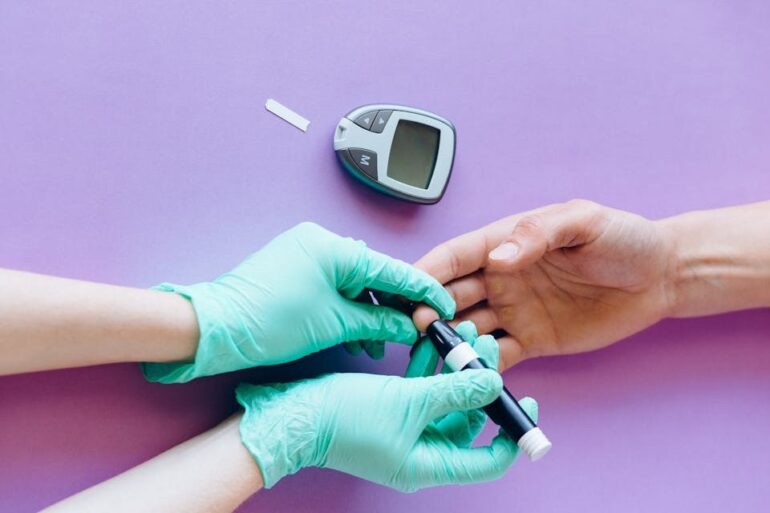 Taking blood sugar levels with the assistance of a healthcare professional